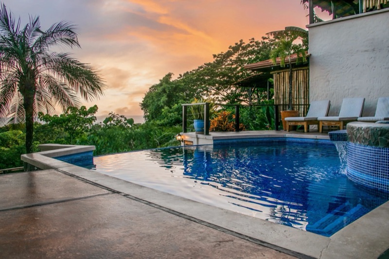 Pool and loungers at sunset at Casa MarBella